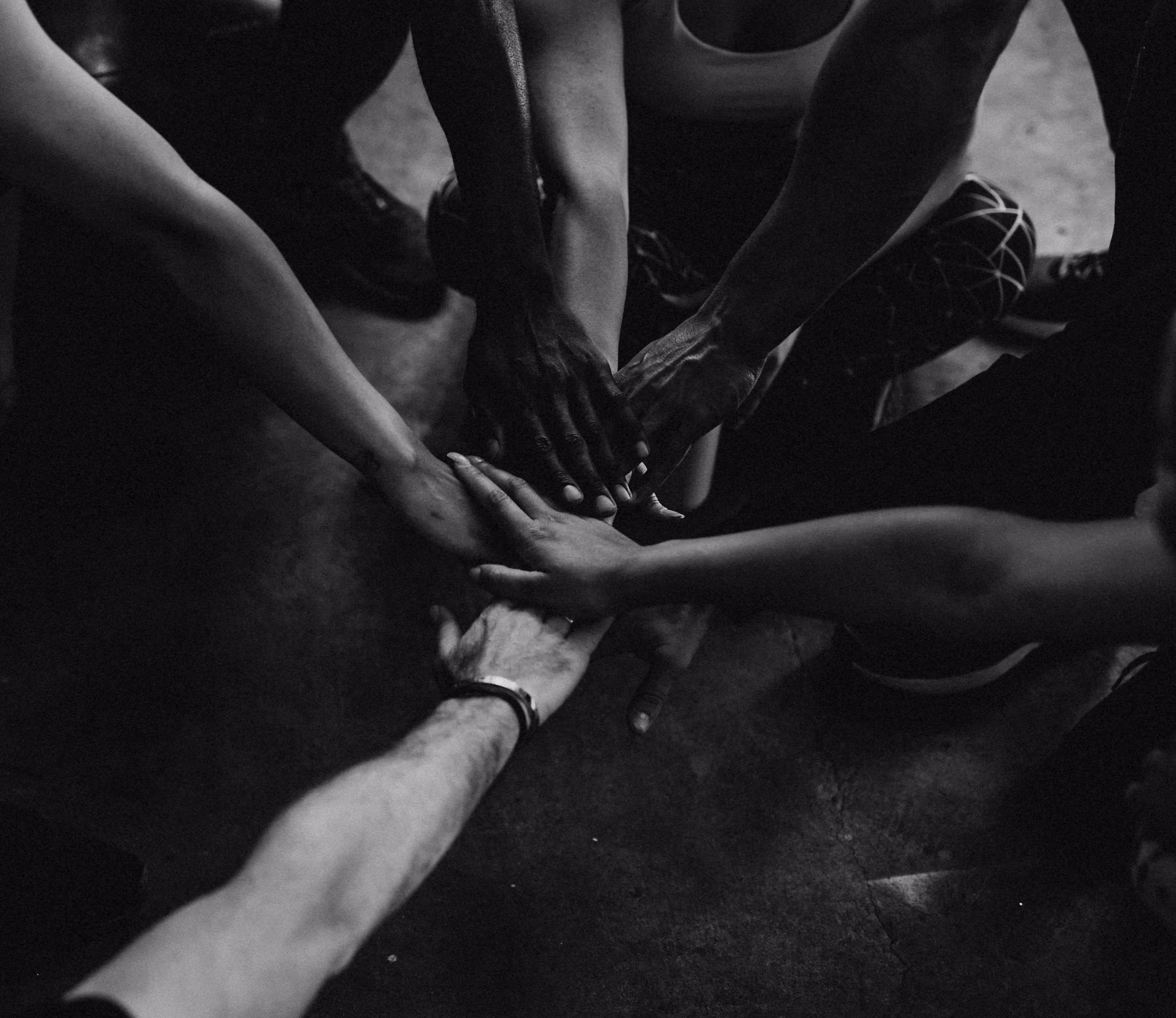 Hands joined together in a gesture of community and support.